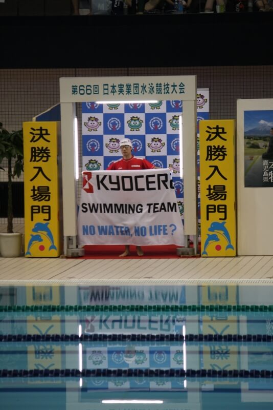 横断幕を掲げる水泳選手